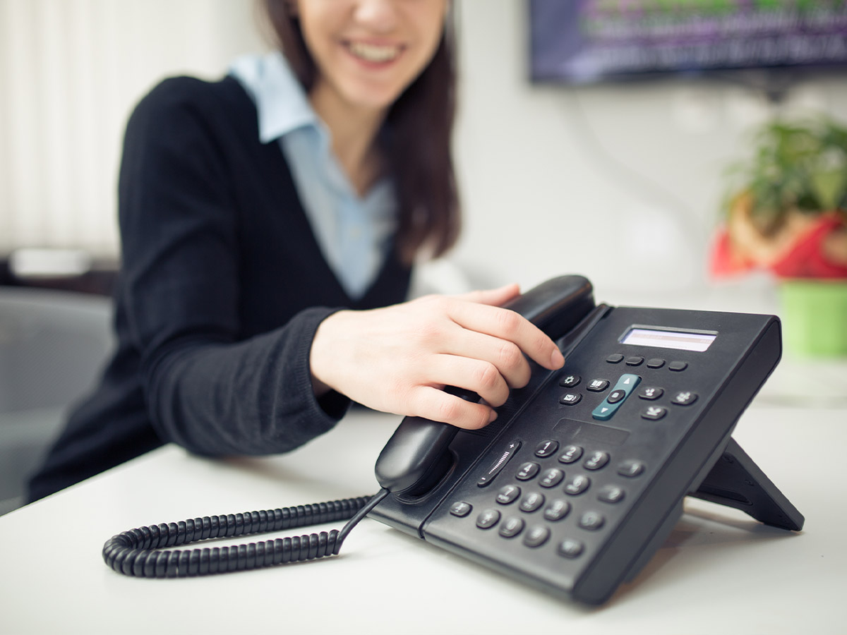 Young business woman answering phone call